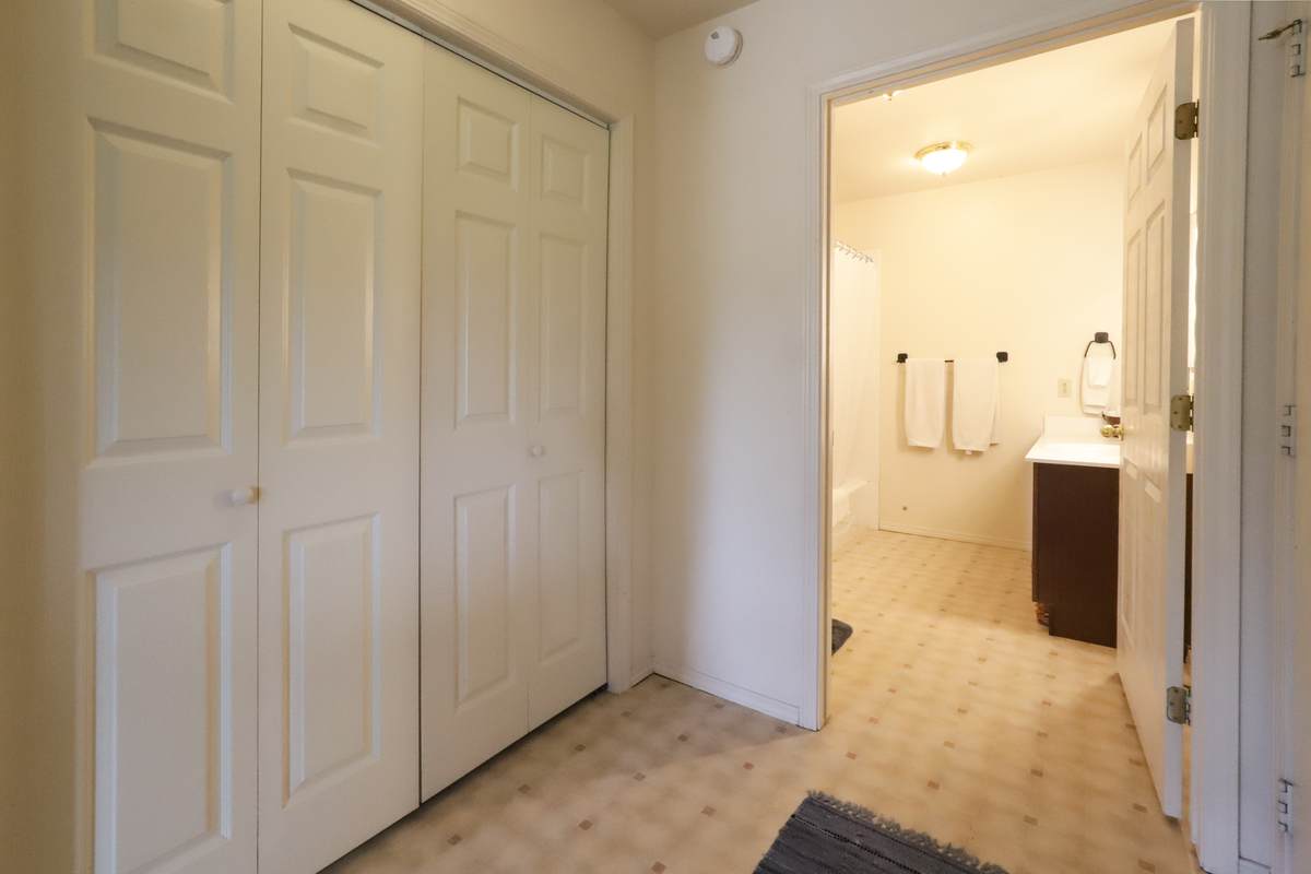 Closet and private bathroom off a main-floor bedroom