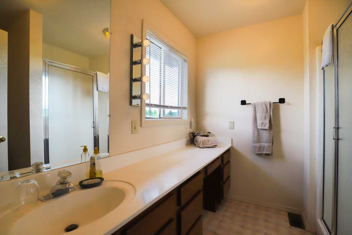 Private bathroom with a long vanity and walk-in shower