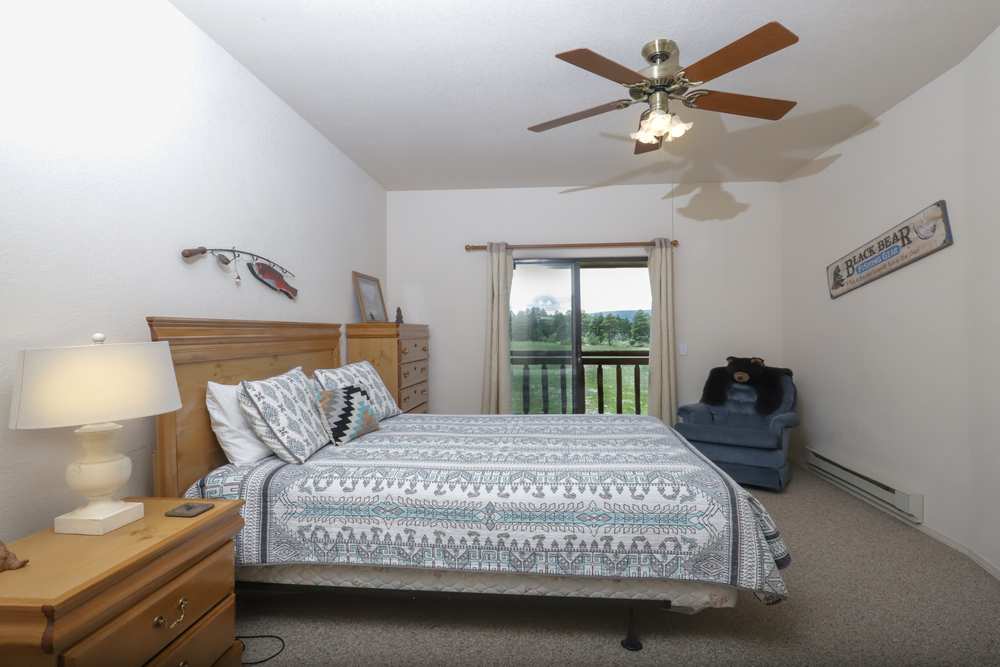 Upper-floor queen bedroom with sliding doors to a private balcony
